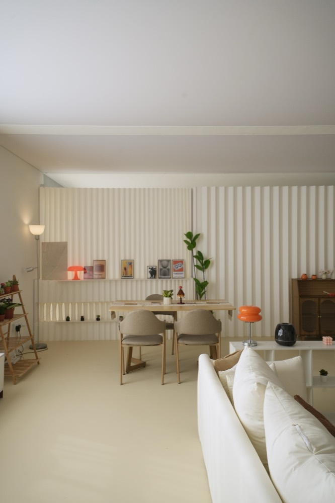 Dining table with chairs, prints shelf and plants